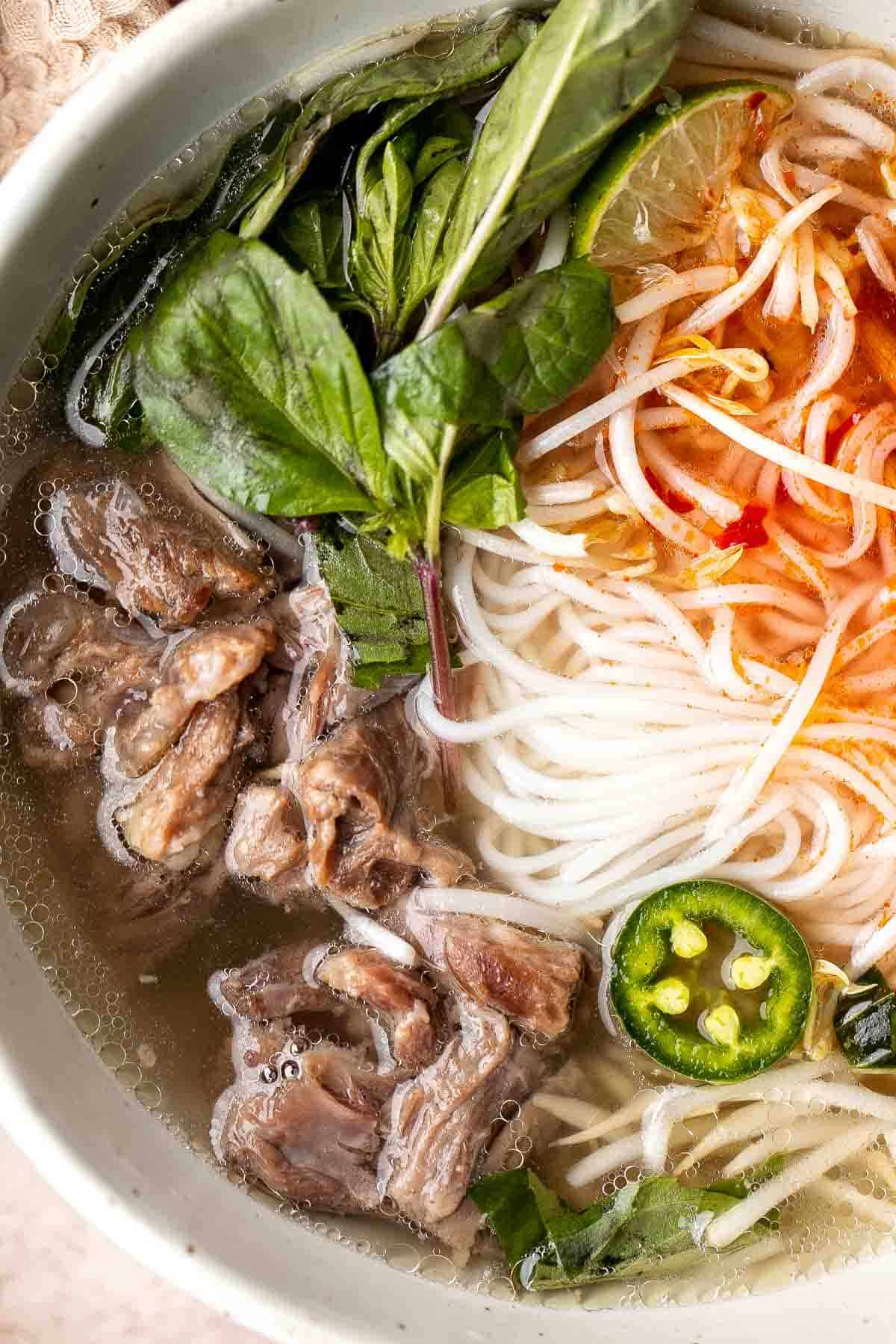 Vietnamese Pho is a one-of-a-kind soup known for its aromatic beef broth served over tender rice noodles, beef sirloin, fresh herbs, and other garnishes. | aheadofthyme.com