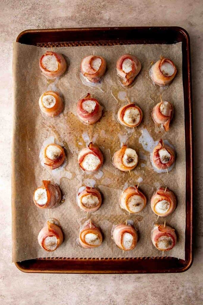 Bacon Wrapped Scallops are the most decadent appetizer to serve at your next part. Tender, fresh scallops are wrapped in bacon slices before baked. | aheadofthyme.com