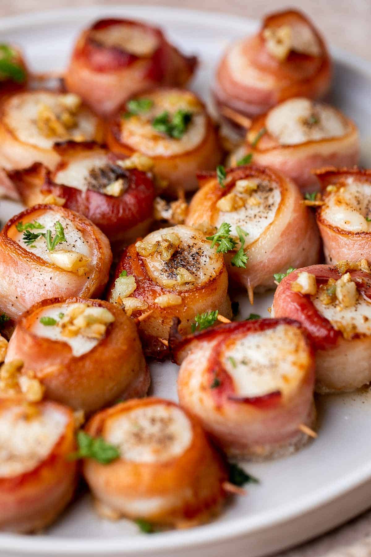 Bacon Wrapped Scallops are the most decadent appetizer to serve at your next part. Tender, fresh scallops are wrapped in bacon slices before baked. | aheadofthyme.com