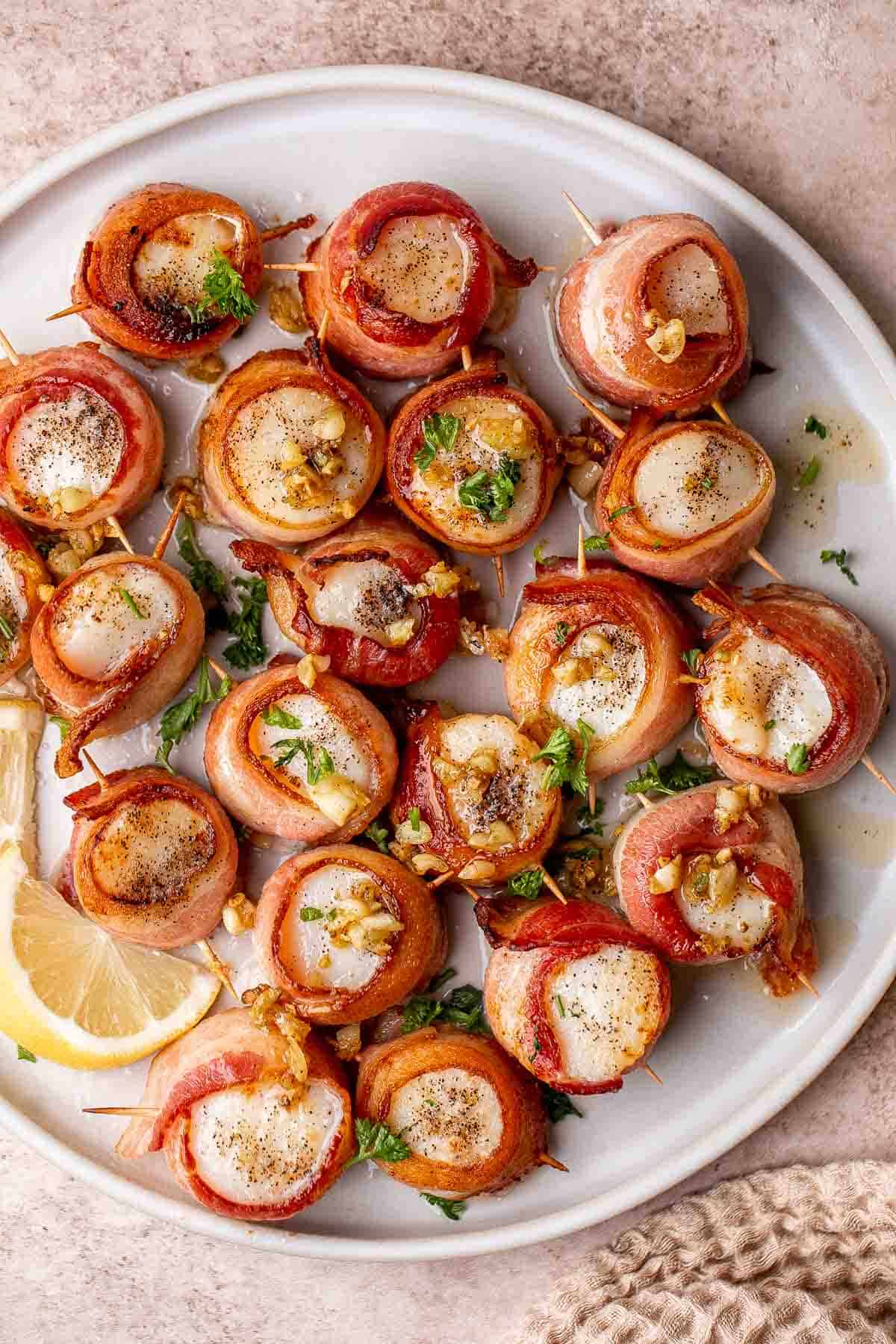 Bacon Wrapped Scallops are the most decadent appetizer to serve at your next part. Tender, fresh scallops are wrapped in bacon slices before baked. | aheadofthyme.com