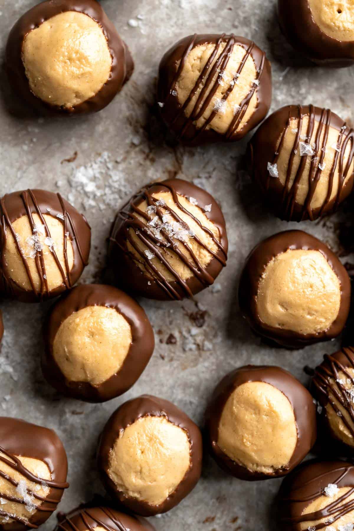 Buckeyes are a classic holiday truffle dessert that's soft and tender with a creamy burst of peanut butter enrobed in a crunchy chocolate shell. | aheadofthyme.com