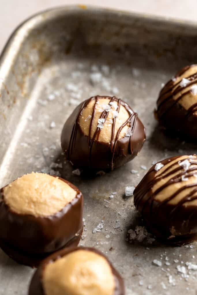 Buckeyes are a classic holiday truffle dessert that's soft and tender with a creamy burst of peanut butter enrobed in a crunchy chocolate shell. | aheadofthyme.com