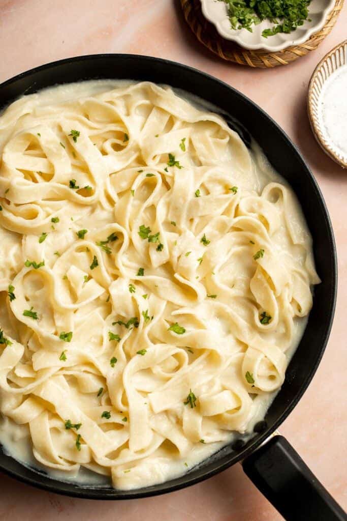 Creamy Cauliflower Alfredo is the perfect way to enjoy your favorite comfort food dinner while sneaking in extra veggies. It tastes like the real thing! | aheadofthyme.com