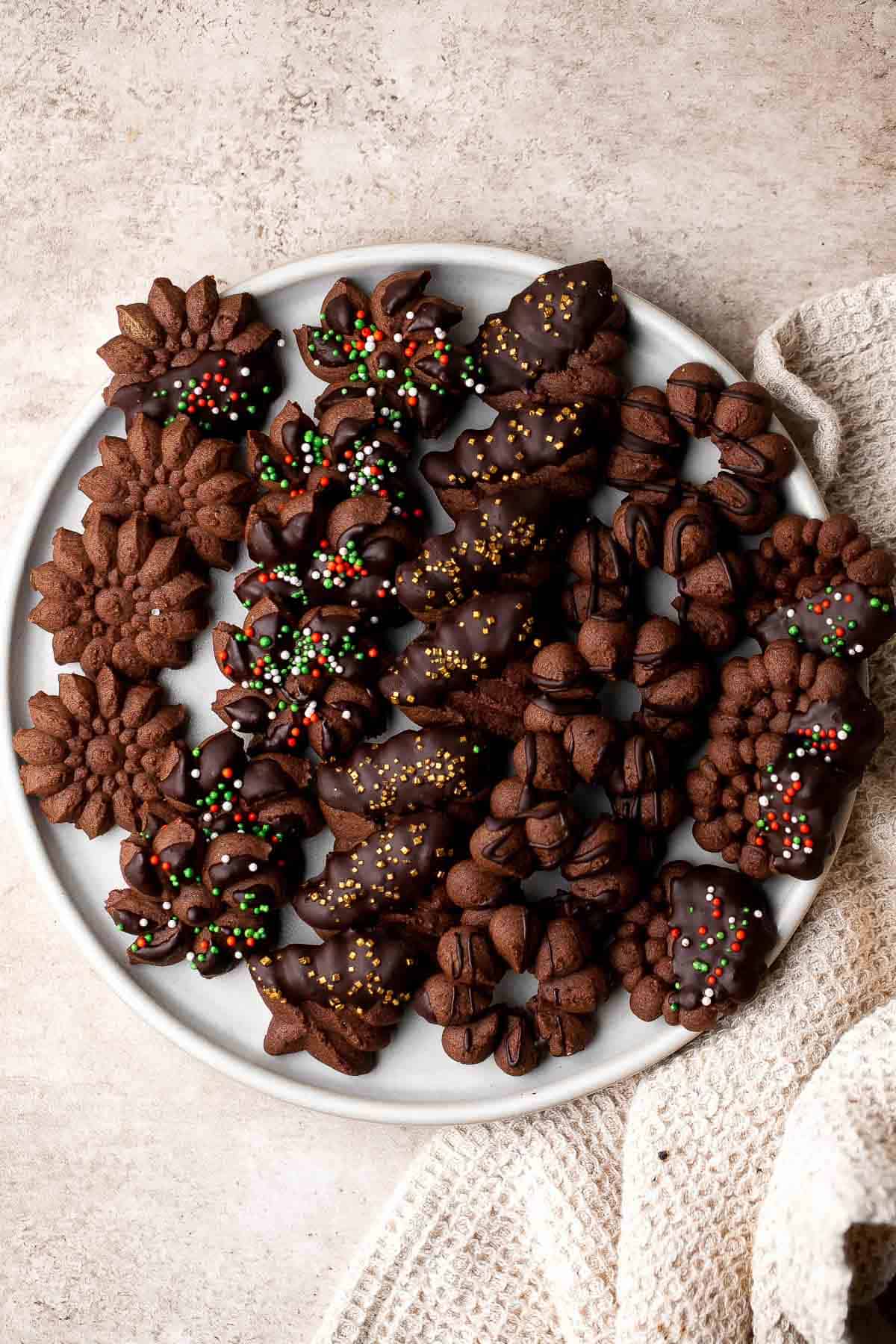 Chocolate Spritz Cookies are a rich and indulgent twist on classic buttery spritz cookies. Dip them in extra chocolate or top with colorful sprinkles. | aheadofthyme.com