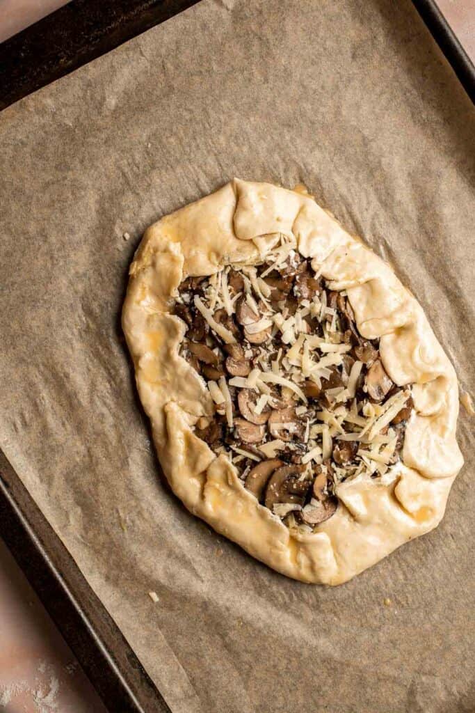 Made with homemade pie crust and an earthy, cheesy mushroom filling, this savory Mushroom Galette is an absolute delight. Serve for appetizer or side dish. | aheadofthyme.com