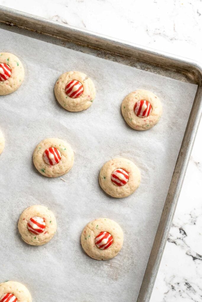 Sweet and crunchy Peppermint Kiss Cookies are the perfect Christmas cookies made with a sugar cookie dough, real candy canes, and a peppermint kiss on top. | aheadofthyme.com