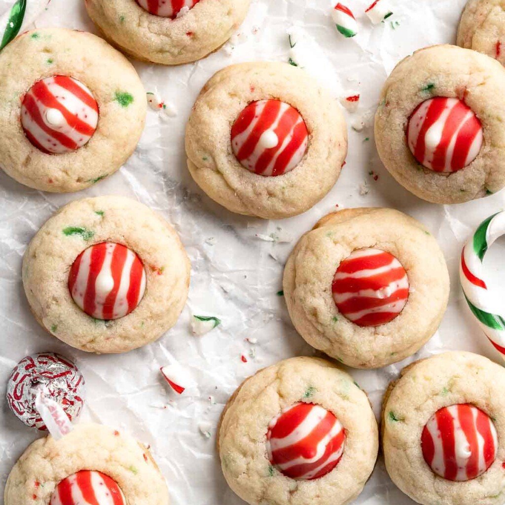Sweet and crunchy Peppermint Kiss Cookies are the perfect Christmas cookies made with a sugar cookie dough, real candy canes, and a peppermint kiss on top. | aheadofthyme.com