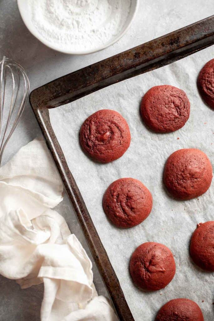 These fluffy Red Velvet Whoopie Pies are made with two soft and moist cake-like cookies, filled with a decadent cream cheese frosting in the middle. | aheadofthyme.com