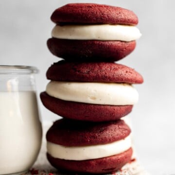 These fluffy Red Velvet Whoopie Pies are made with two soft and moist cake-like cookies, filled with a decadent cream cheese frosting in the middle. | aheadofthyme.com