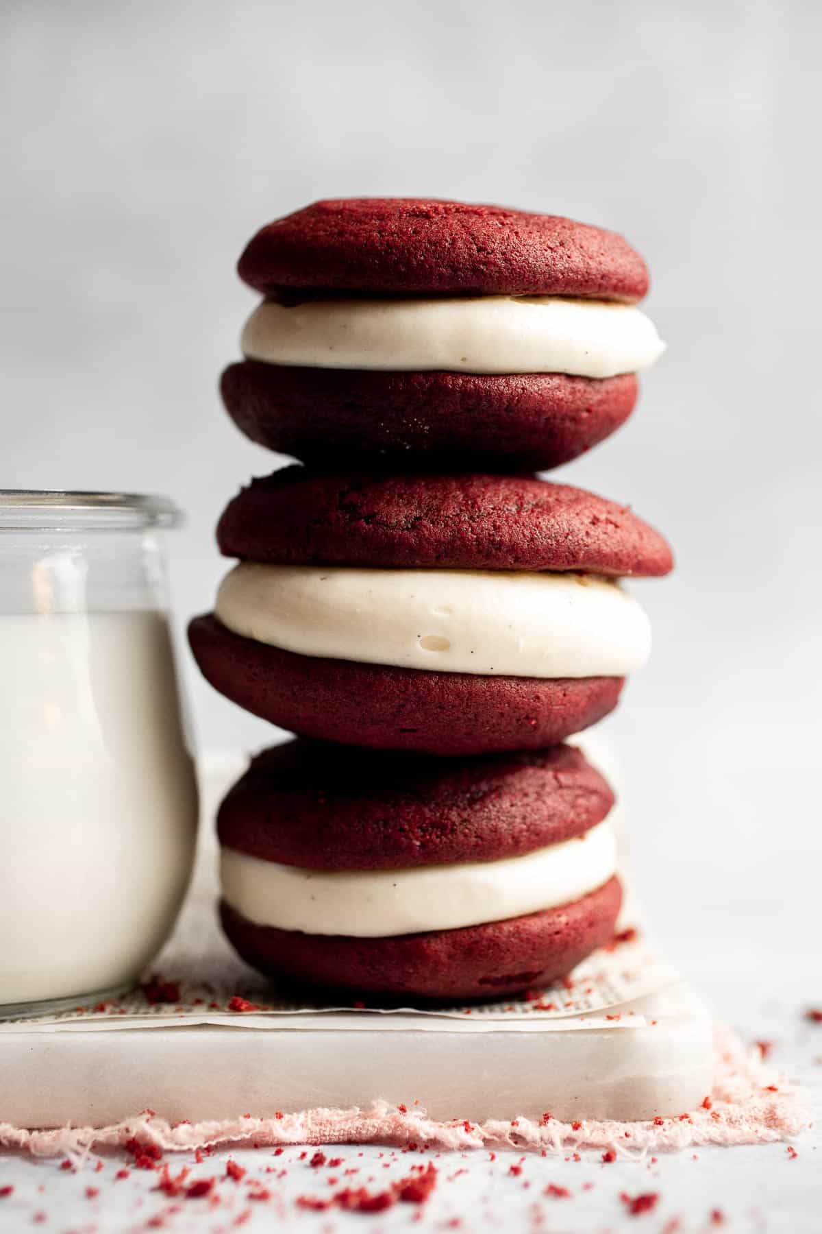These fluffy Red Velvet Whoopie Pies are made with two soft and moist cake-like cookies, filled with a decadent cream cheese frosting in the middle. | aheadofthyme.com