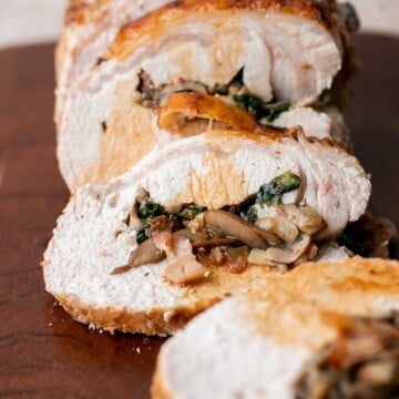 This juicy tender Stuffed Pork Loin filled with a delicious mushroom and spinach stuffing is a gorgeous entree to serve at your next dinner party. | aheadofthyme.com