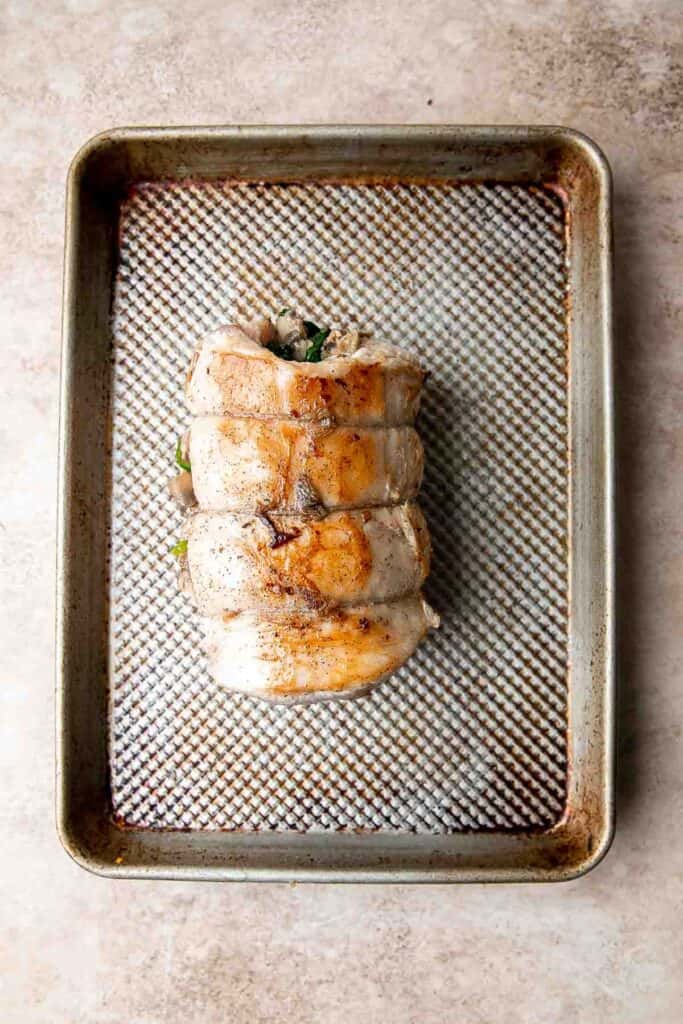 This juicy tender Stuffed Pork Loin filled with a delicious mushroom and spinach stuffing is a gorgeous entree to serve at your next dinner party. | aheadofthyme.com