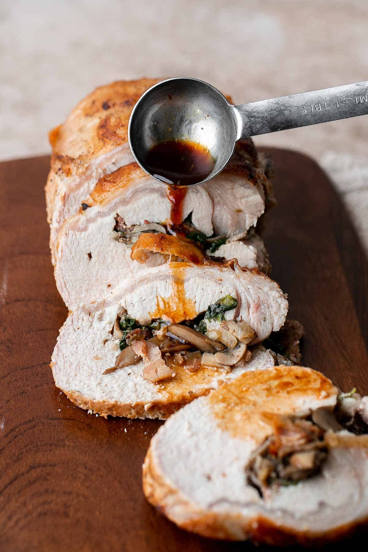 This juicy tender Stuffed Pork Loin filled with a delicious mushroom and spinach stuffing is a gorgeous entree to serve at your next dinner party. | aheadofthyme.com