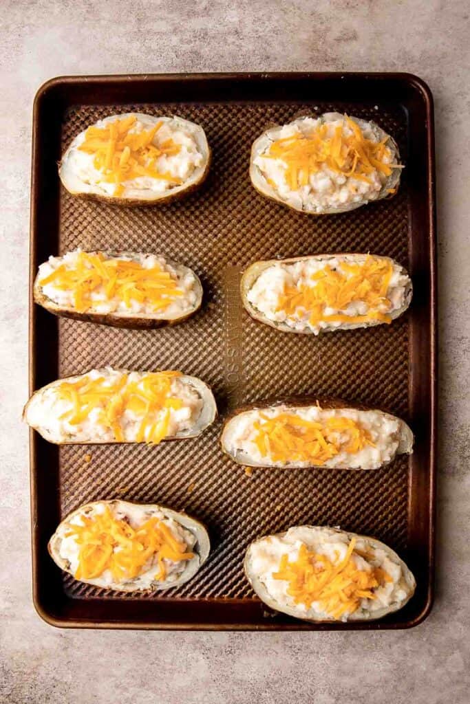 Twice Baked Potatoes are the perfect side dish or appetizer with tender baked potato boats, gooey, cheesy filling, and classic baked potato toppings. | aheadofthyme.com