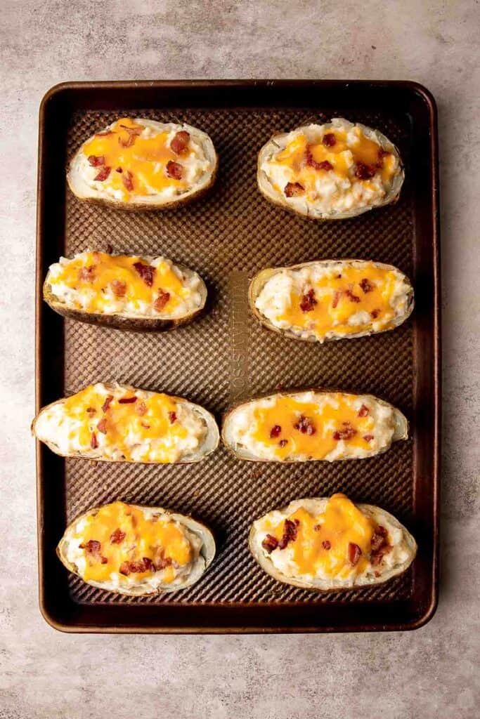 Twice Baked Potatoes are the perfect side dish or appetizer with tender baked potato boats, gooey, cheesy filling, and classic baked potato toppings. | aheadofthyme.com