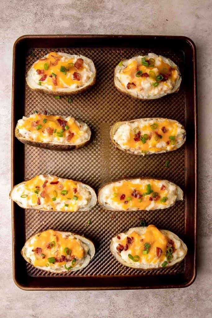 Twice Baked Potatoes are the perfect side dish or appetizer with tender baked potato boats, gooey, cheesy filling, and classic baked potato toppings. | aheadofthyme.com