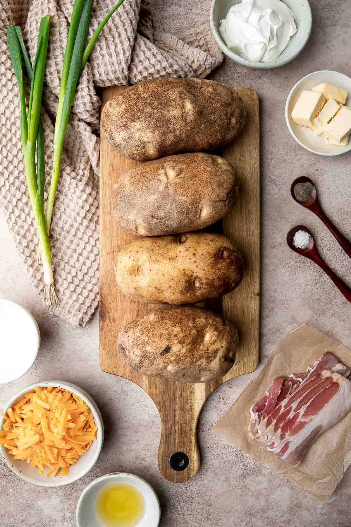 Twice Baked Potatoes are the perfect side dish or appetizer with tender baked potato boats, gooey, cheesy filling, and classic baked potato toppings. | aheadofthyme.com