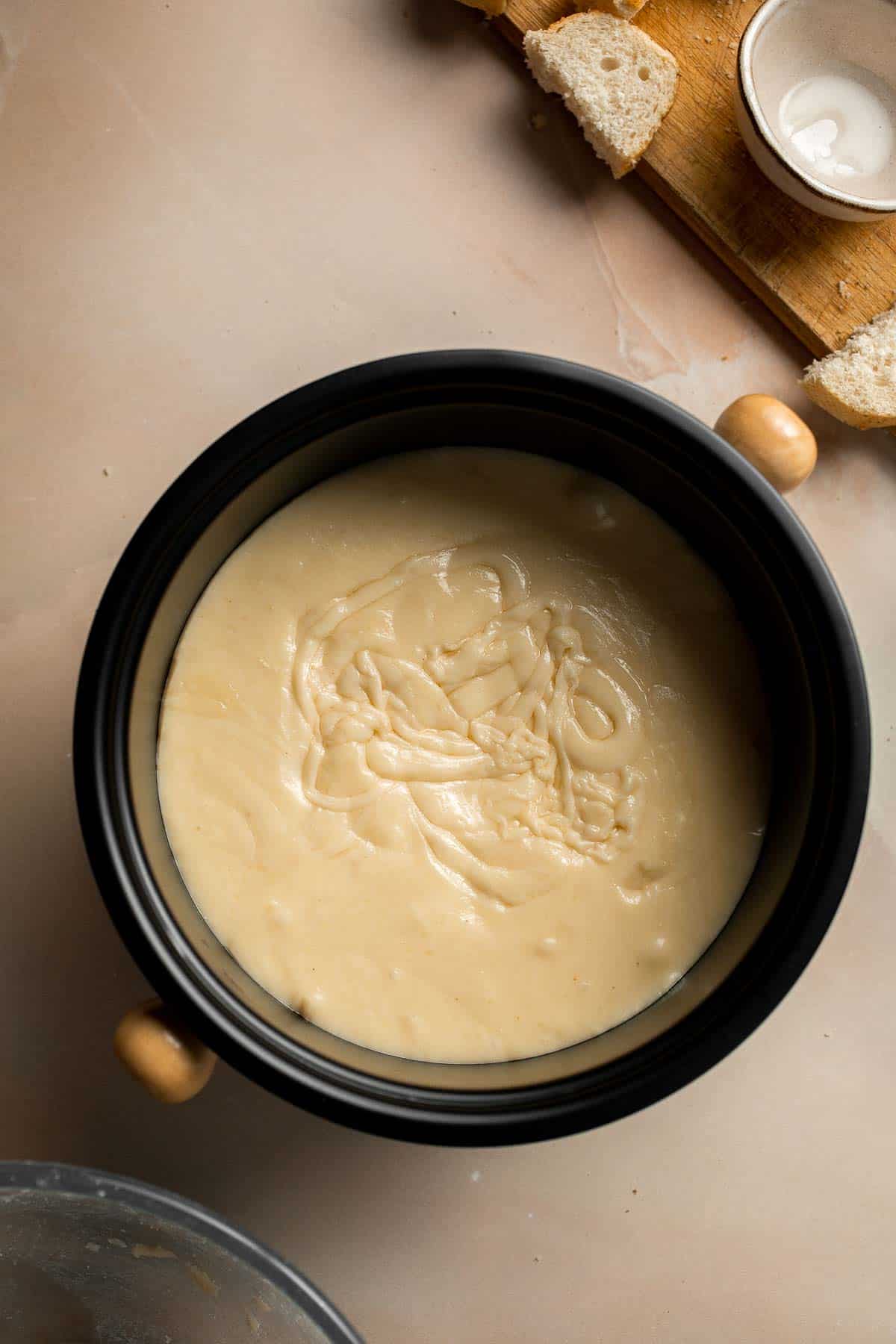 This Swiss Cheese Fondue with warm, melty cheese is a classic. Serve it as a quick and easy appetizer or dinner with bread, potatoes, and more. | aheadofthyme.com