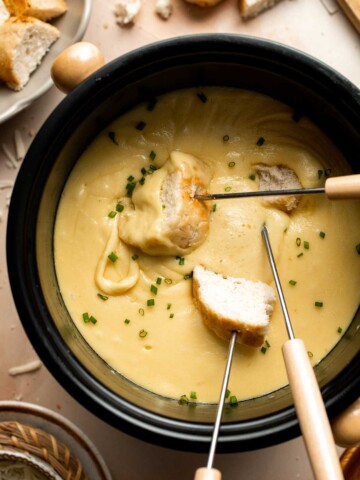 This Swiss Cheese Fondue with warm, melty cheese is a classic. Serve it as a quick and easy appetizer or dinner with bread, potatoes, and more. | aheadofthyme.com