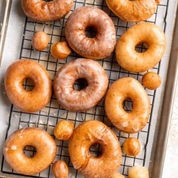 Homemade Glazed Donuts are made with tender, pillowy dough and topped with a sweet glaze. Making doughnuts at home are a lot easier than you'd think! | aheadofthyme.com