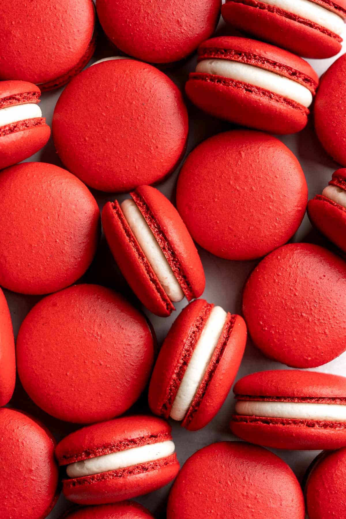 These homemade Red Velvet Macarons with cream cheese frosting are like the beloved cake but in bite-sized form — bold red color and a hint of cocoa flavor. | aheadofthyme.com