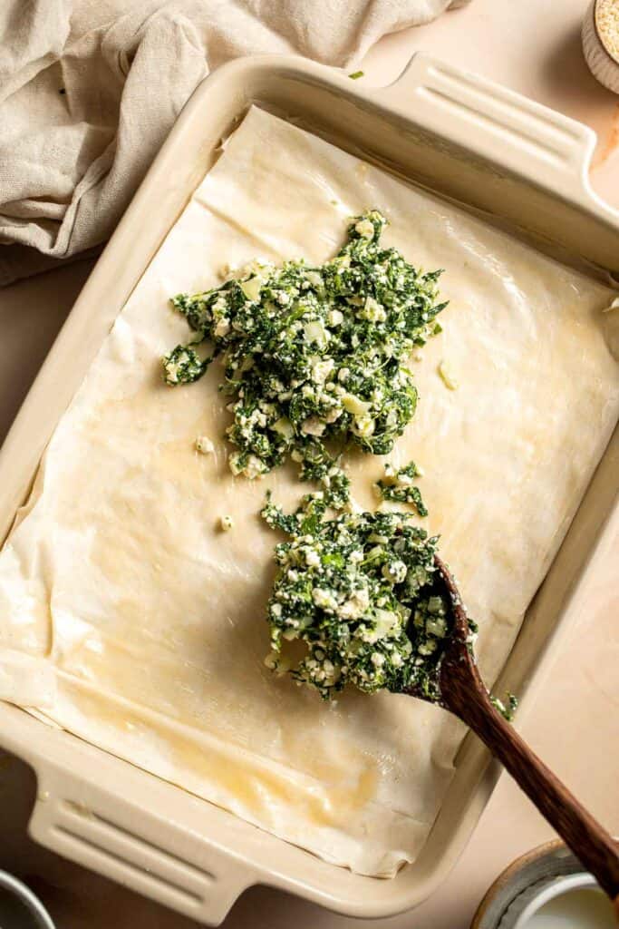 Spanakopita is a traditional Greek savory pie famous worldwide for its cheesy spinach filling nestled between layers of phyllo dough. It's easy to make too! | aheadofthyme.com