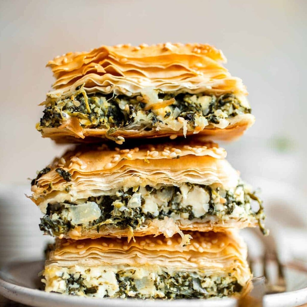 Spanakopita is a traditional Greek savory pie famous worldwide for its cheesy spinach filling nestled between layers of phyllo dough. It's easy to make too! | aheadofthyme.com