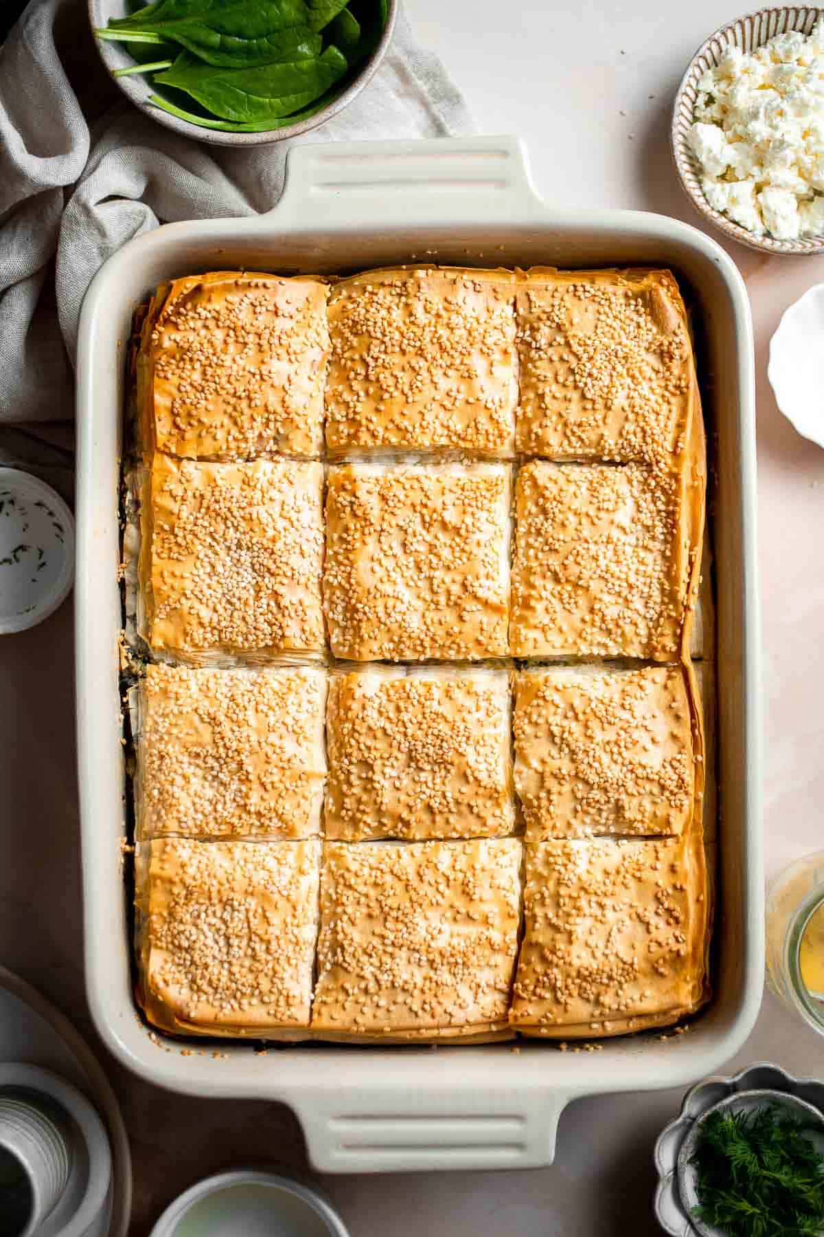 Spanakopita is a traditional Greek savory pie famous worldwide for its cheesy spinach filling nestled between layers of phyllo dough. It's easy to make too! | aheadofthyme.com