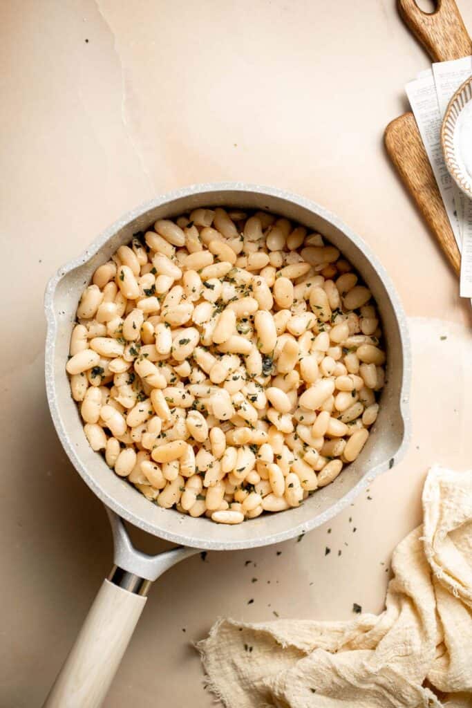 One pot Cannellini Beans are creamy, buttery, and nourishing. Serve them as a simple vegan side dish or as a delicious addition to soups, salads, and more. | aheadofthyme.com