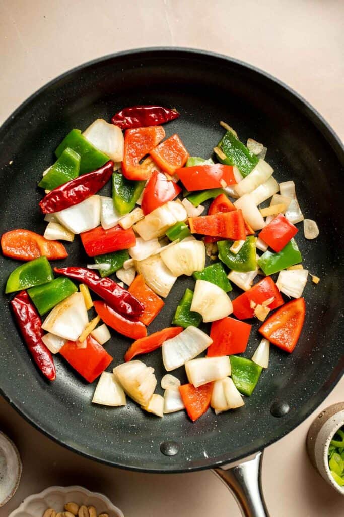 This homemade Kung Pao Tofu, made with perfectly crispy pan-fried tofu tossed in the most delicious sauce with peppers and onions is ready in 25 minutes. | aheadofthyme.com