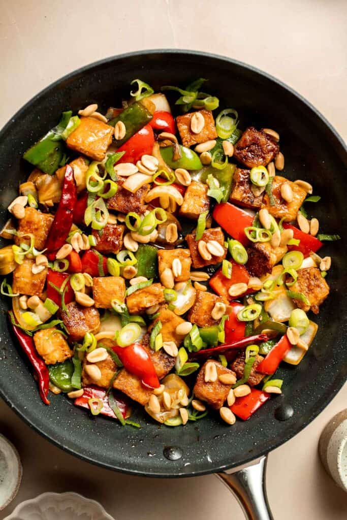 This homemade Kung Pao Tofu, made with perfectly crispy pan-fried tofu tossed in the most delicious sauce with peppers and onions is ready in 25 minutes. | aheadofthyme.com