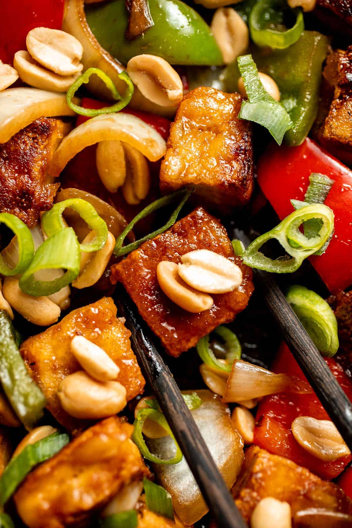 This homemade Kung Pao Tofu, made with perfectly crispy pan-fried tofu tossed in the most delicious sauce with peppers and onions is ready in 25 minutes. | aheadofthyme.com