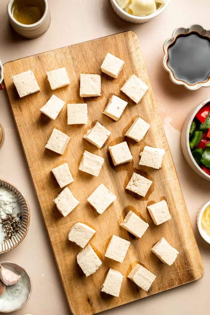 This homemade Kung Pao Tofu, made with perfectly crispy pan-fried tofu tossed in the most delicious sauce with peppers and onions is ready in 25 minutes. | aheadofthyme.com