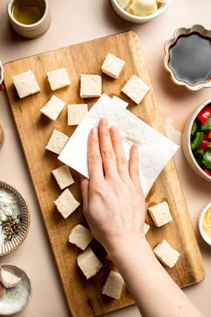 This homemade Kung Pao Tofu, made with perfectly crispy pan-fried tofu tossed in the most delicious sauce with peppers and onions is ready in 25 minutes. | aheadofthyme.com