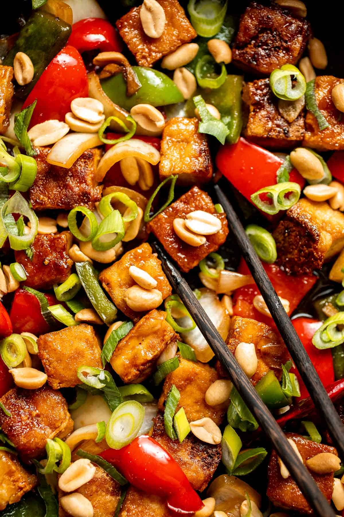 This homemade Kung Pao Tofu, made with perfectly crispy pan-fried tofu tossed in the most delicious sauce with peppers and onions is ready in 25 minutes. | aheadofthyme.com