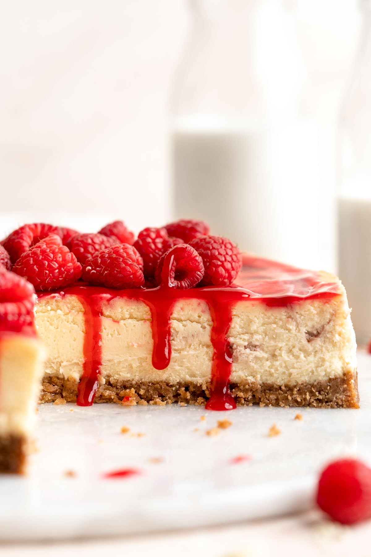 This White Chocolate Raspberry Cheesecake is so decadent, made with a creamy white chocolate cheesecake batter swirled with homemade raspberry sauce. | aheadofthyme.com