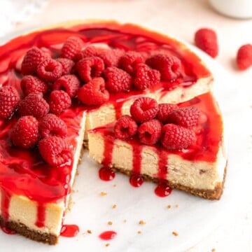 This White Chocolate Raspberry Cheesecake is so decadent, made with a creamy white chocolate cheesecake batter swirled with homemade raspberry sauce. | aheadofthyme.com