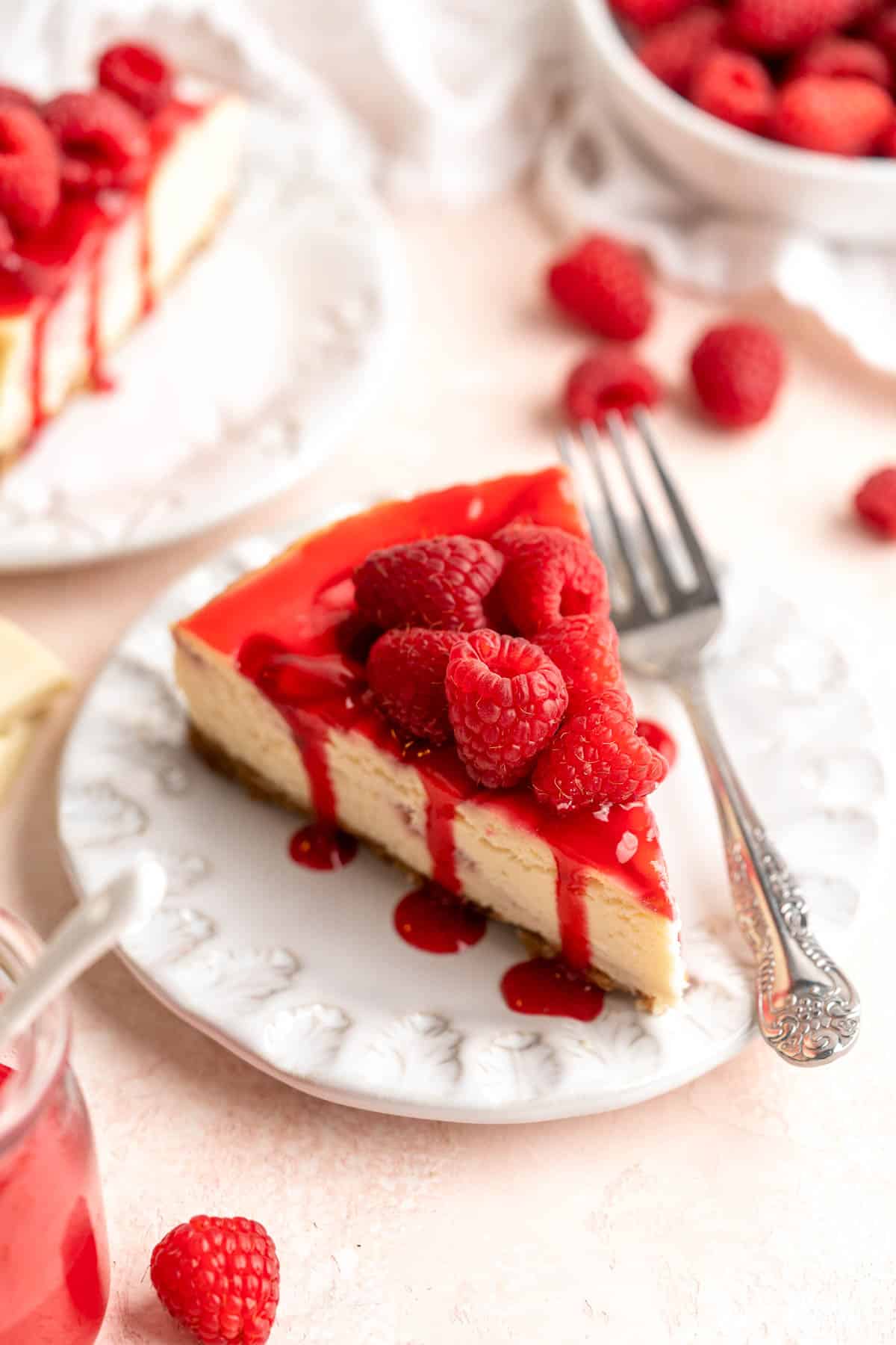 This White Chocolate Raspberry Cheesecake is so decadent, made with a creamy white chocolate cheesecake batter swirled with homemade raspberry sauce. | aheadofthyme.com