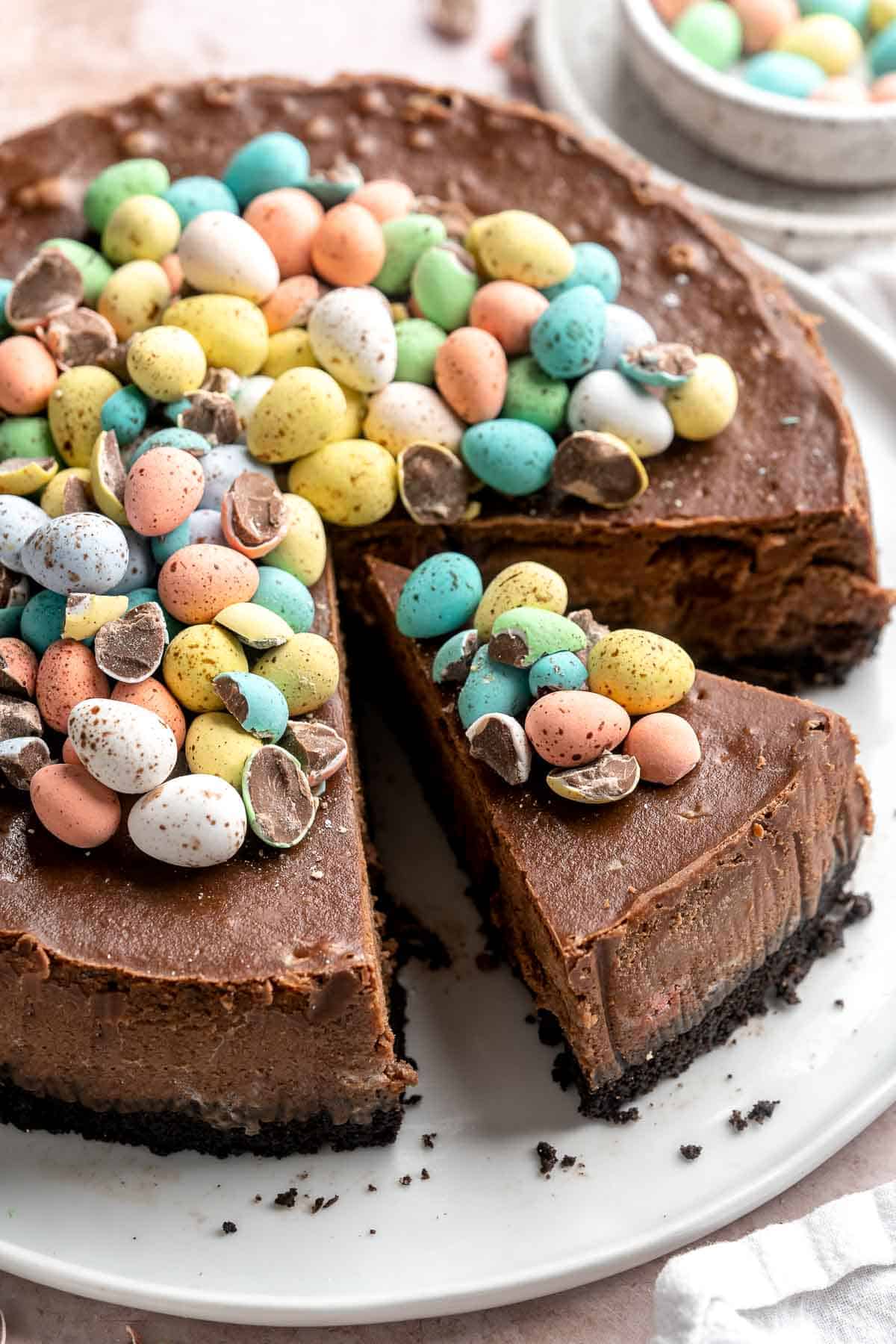 Mini Egg Easter Cheesecake is a rich and decadent triple chocolate cheesecake with an Oreo crust, chocolate cheesecake filling, and topped with mini eggs. | aheadofthyme.com