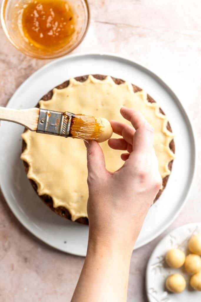 Simnel Cake is a traditional Easter fruitcake that is light and citrusy with two layers of marzipan which adds a delicious nutty flavor. | aheadofthyme.com