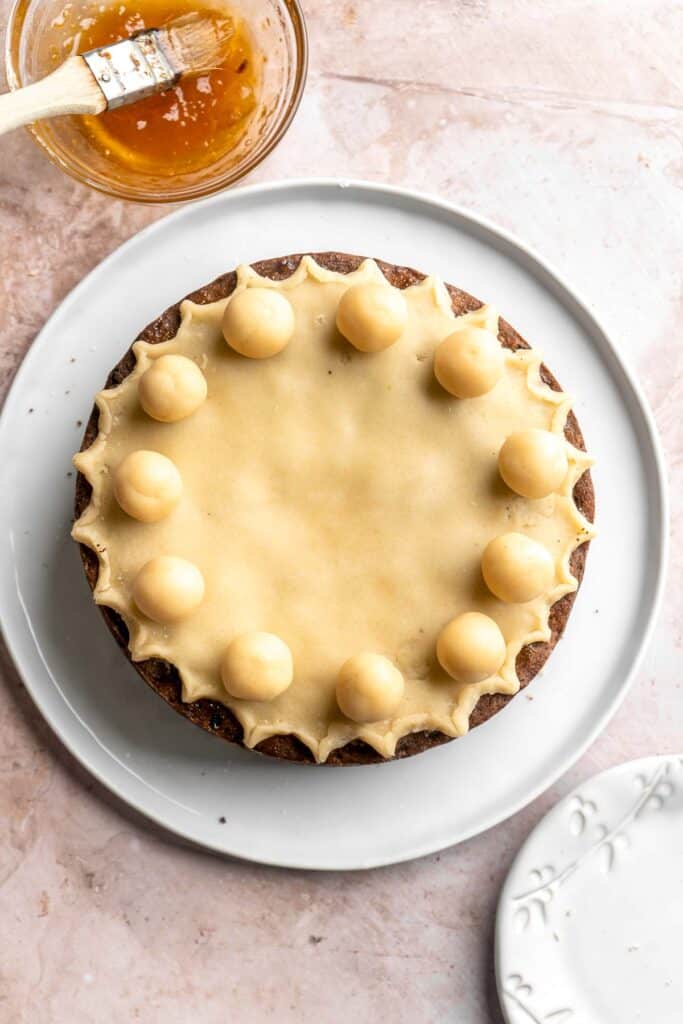 Simnel Cake is a traditional Easter fruitcake that is light and citrusy with two layers of marzipan which adds a delicious nutty flavor. | aheadofthyme.com