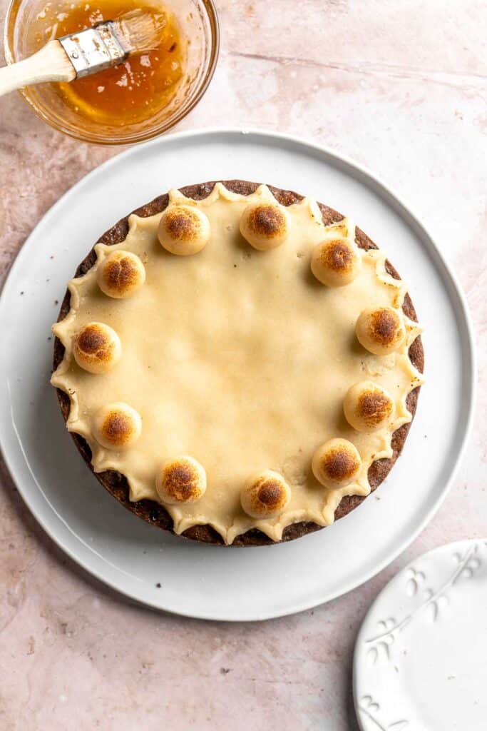 Simnel Cake is a traditional Easter fruitcake that is light and citrusy with two layers of marzipan which adds a delicious nutty flavor. | aheadofthyme.com