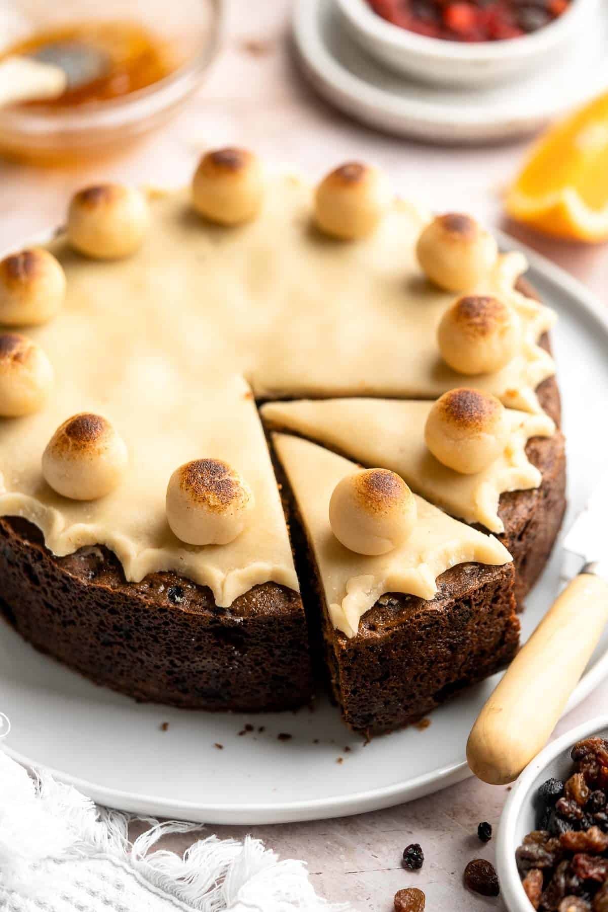 Simnel Cake is a traditional Easter fruitcake that is light and citrusy with two layers of marzipan which adds a delicious nutty flavor. | aheadofthyme.com