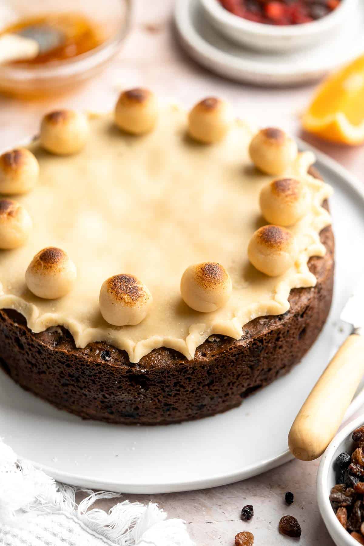 Simnel Cake is a traditional Easter fruitcake that is light and citrusy with two layers of marzipan which adds a delicious nutty flavor. | aheadofthyme.com