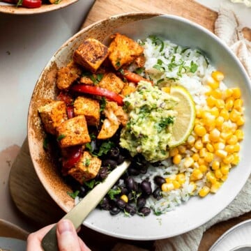Skip the trip to the burrito shop and make this Vegetarian Burrito Bowl at home, loaded with cilantro lime rice, tofu, veggies, and delicious toppings. | aheadofthyme.com