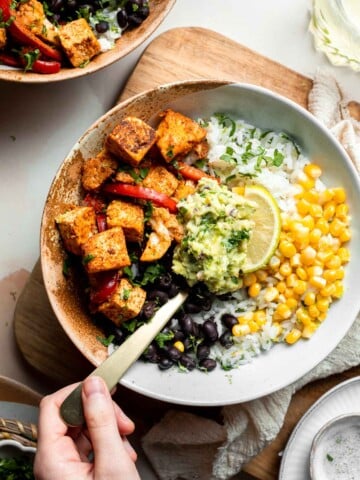 Skip the trip to the burrito shop and make this Vegetarian Burrito Bowl at home, loaded with cilantro lime rice, tofu, veggies, and delicious toppings. | aheadofthyme.com