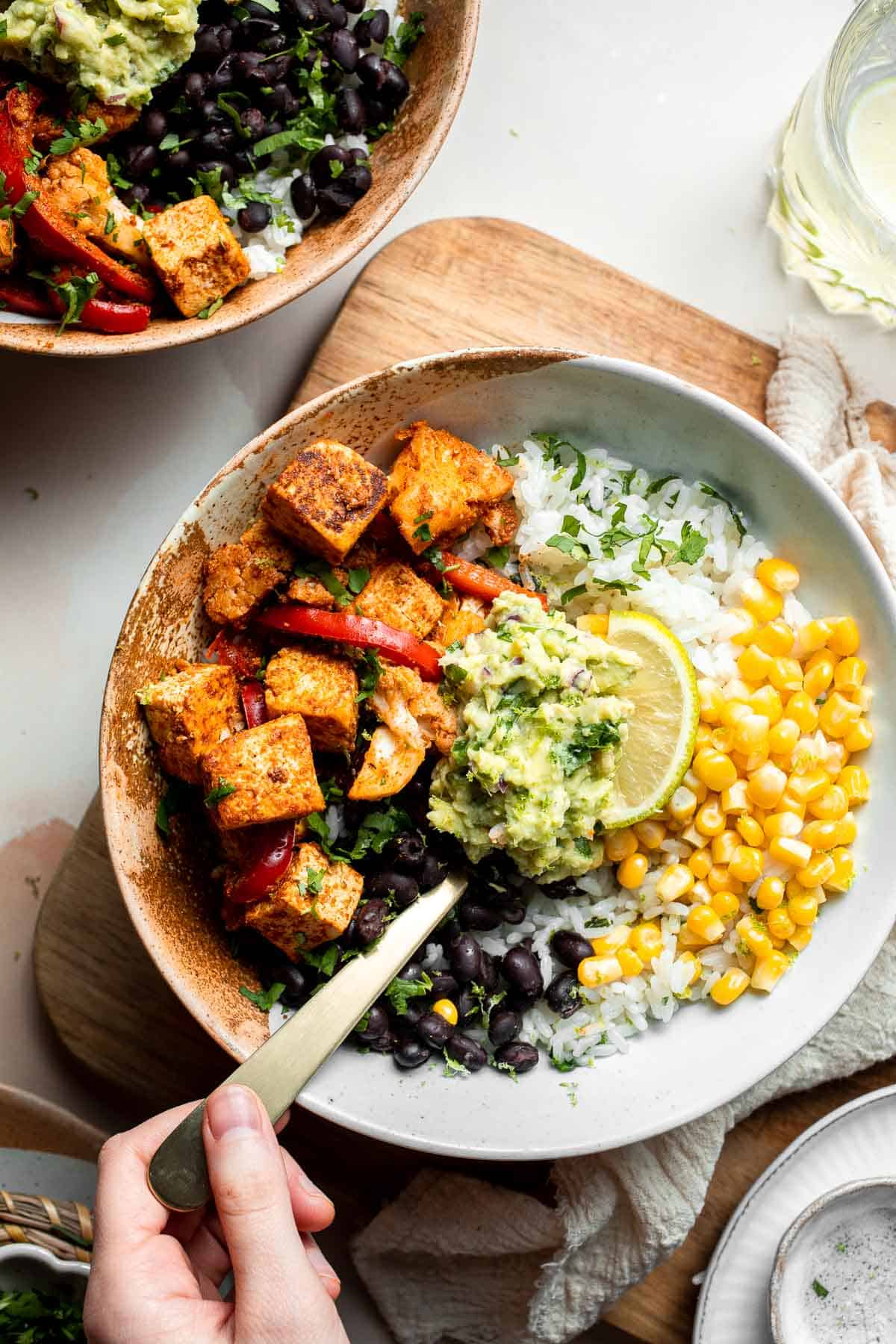 Skip the trip to the burrito shop and make this Vegetarian Burrito Bowl at home, loaded with cilantro lime rice, tofu, veggies, and delicious toppings. | aheadofthyme.com