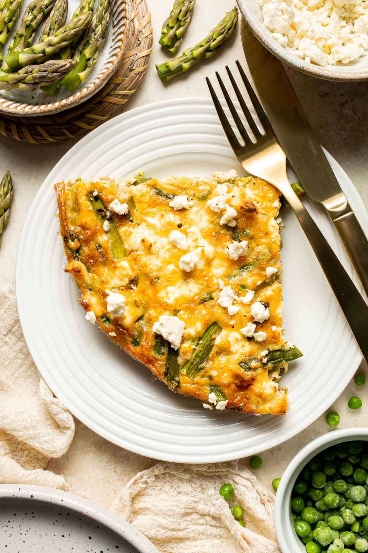 This Asparagus Frittata, made with sautéed asparagus and peas baked with eggs and creamy feta cheese, is perfect for your next spring brunch! | aheadofthyme.com