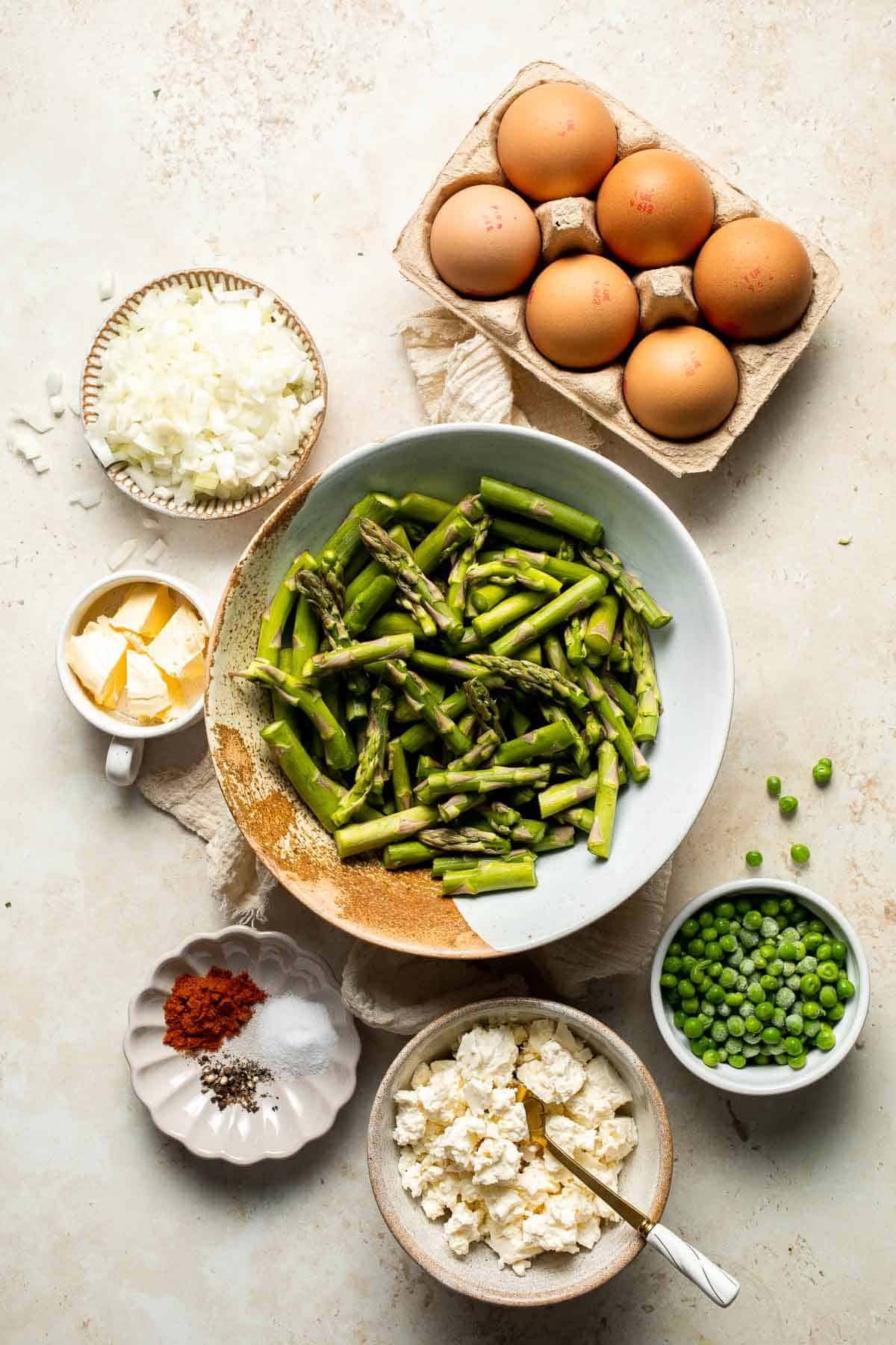 This Asparagus Frittata, made with sautéed asparagus and peas baked with eggs and creamy feta cheese, is perfect for your next spring brunch! | aheadofthyme.com