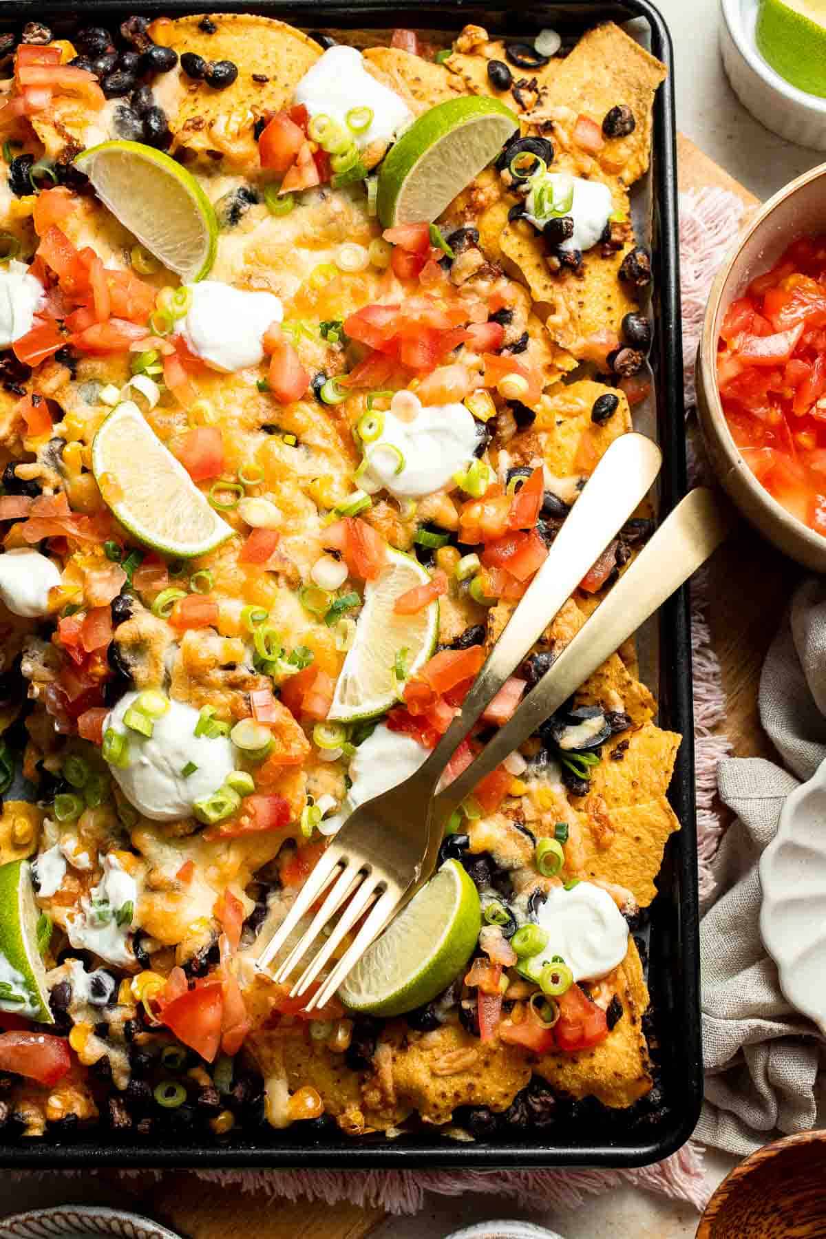 These loaded Black Bean Nachos are the ultimate vegetarian appetizer or snack — warm, crunchy, gooey, and so easy to make. | aheadofthyme.com